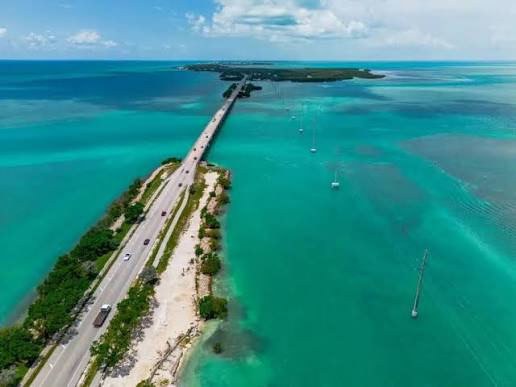 Aerial view of the Overseas Highway crossing turquoise water between two Keys